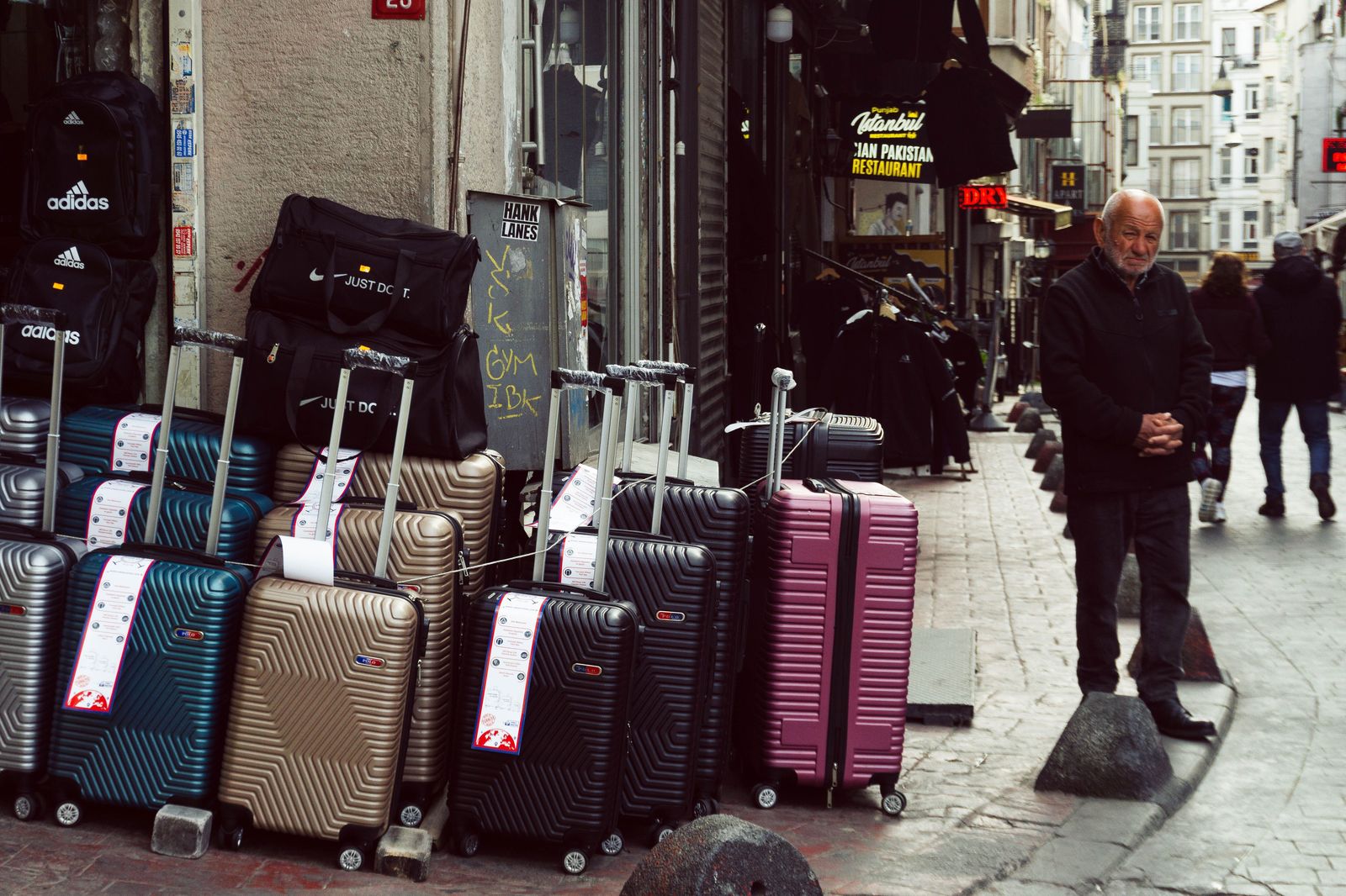 A chauffeur loading a traveller's suitcase outside a downtown Toronto condo before the run to Pearson