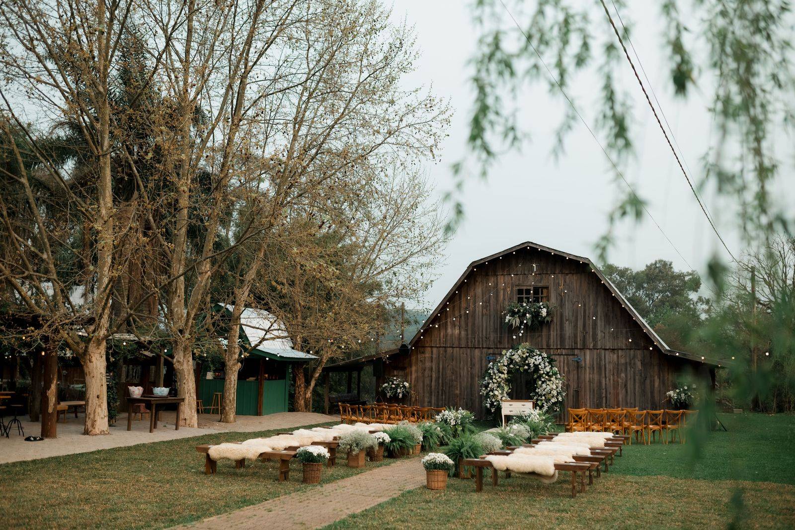 An outdoor wedding reception with string lights at a barn venue in King Township