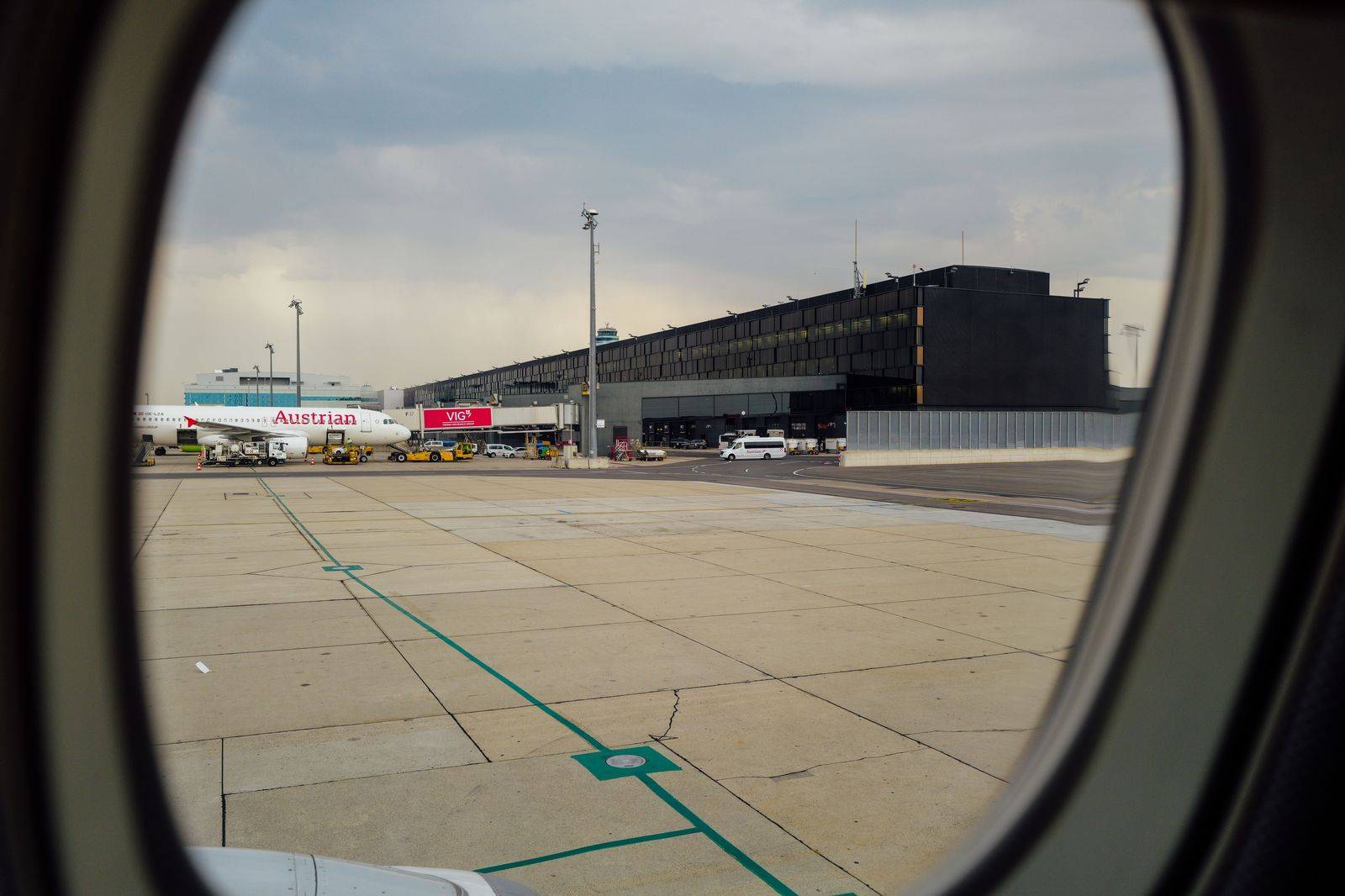 A black sedan waiting at an airport terminal curb for a traveller heading to London, Ontario