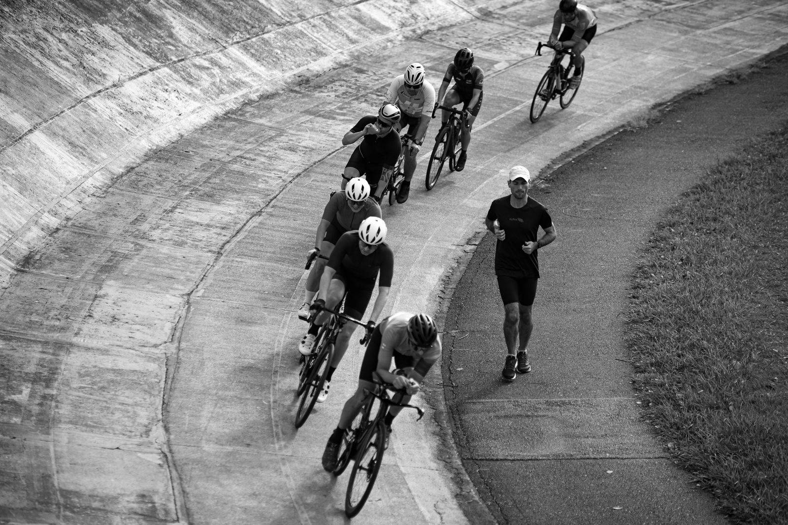 An indoor velodrome track with cyclists racing