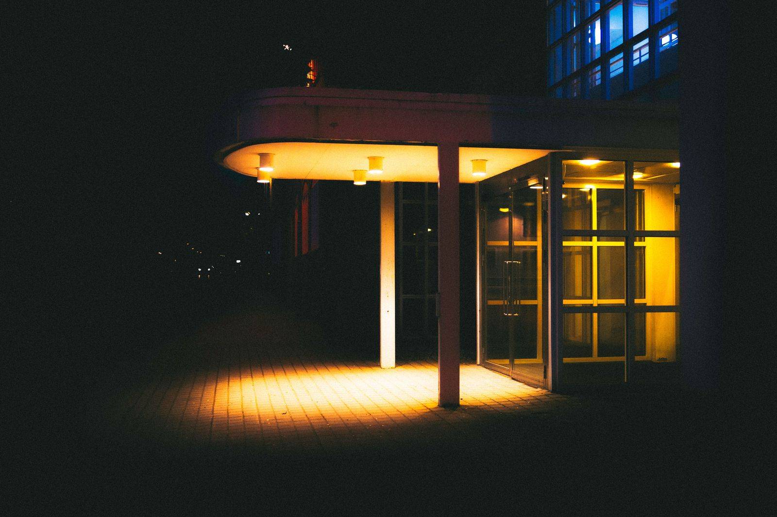 The entrance of a lakeside casino resort lit up at night