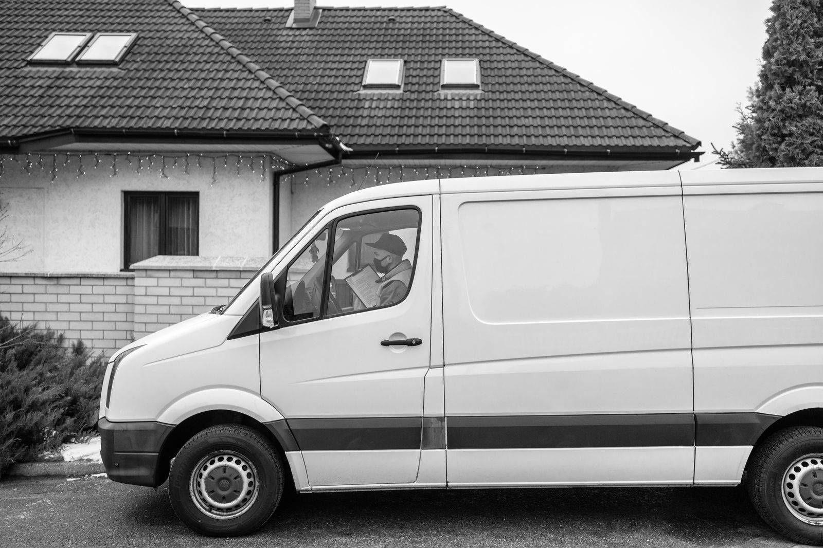 A black van loading a family's luggage in a Scarborough driveway before a Pearson departure