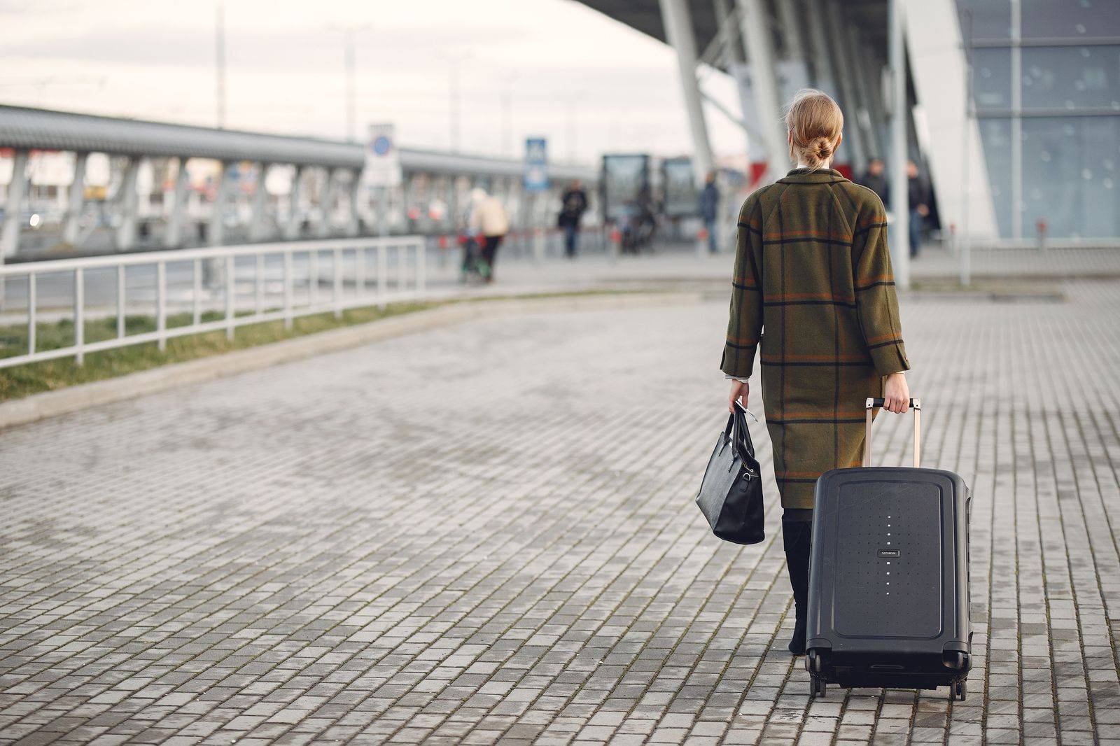Traveller with a suitcase in the arrivals hall at a Toronto airport