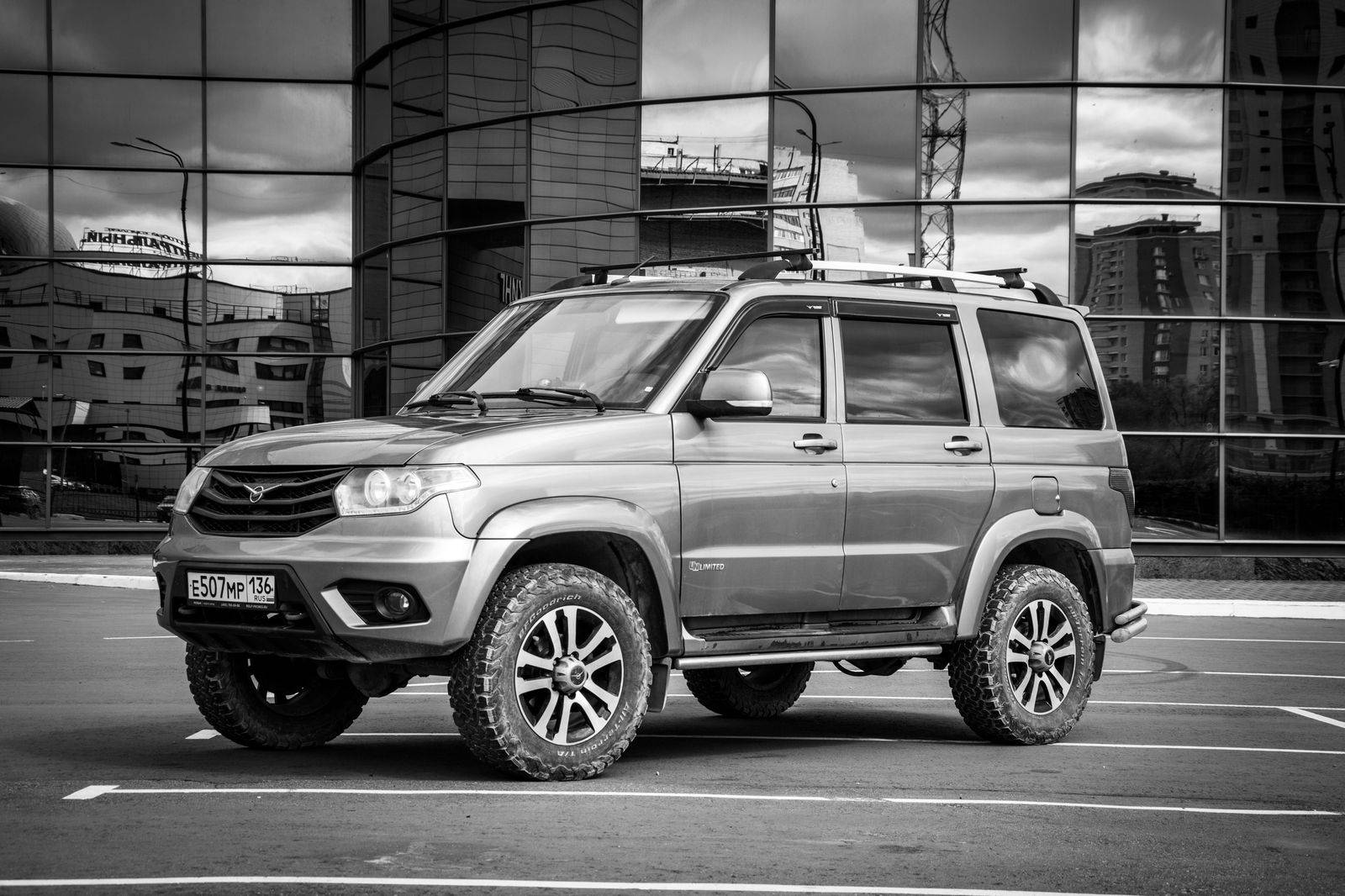A black SUV waits on a quiet side street away from the festival crowd