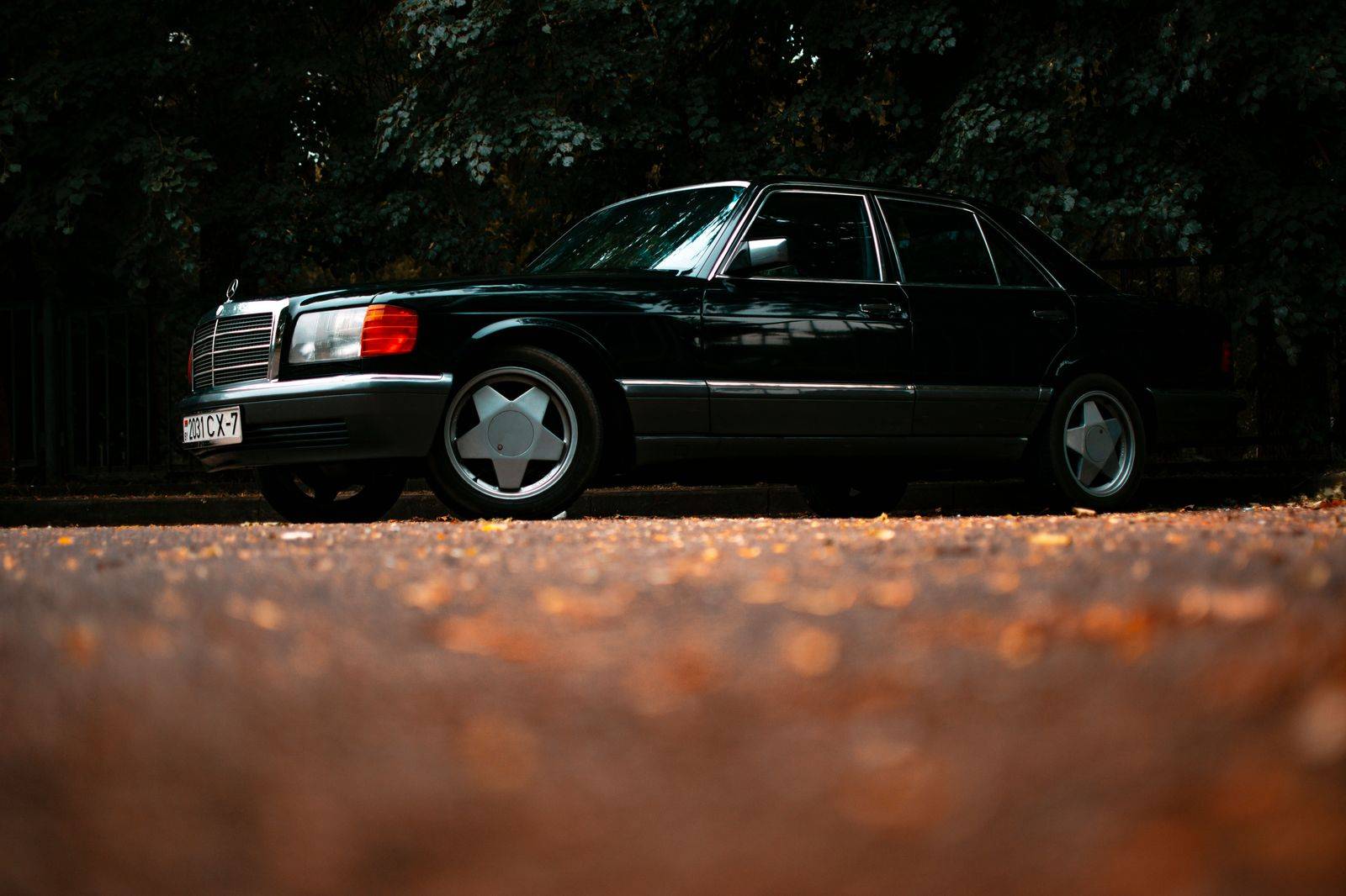 A black sedan parked on a historic downtown street