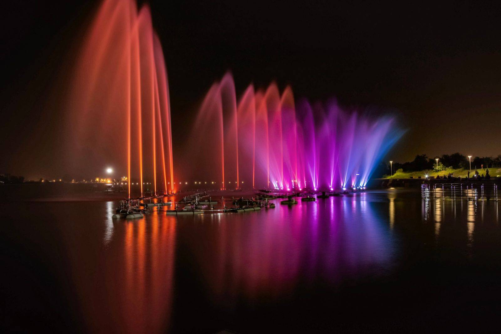 An outdoor art installation lit up on the Toronto waterfront during a June festival