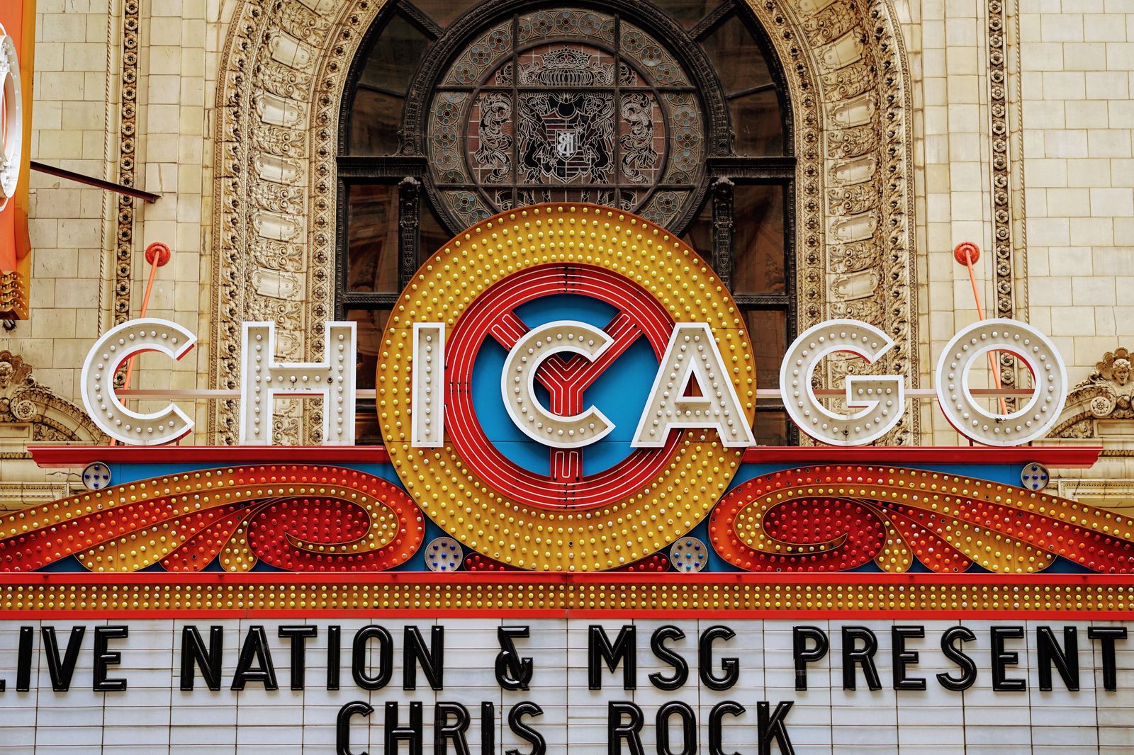 A theatre marquee lit up for an evening performance in downtown Toronto