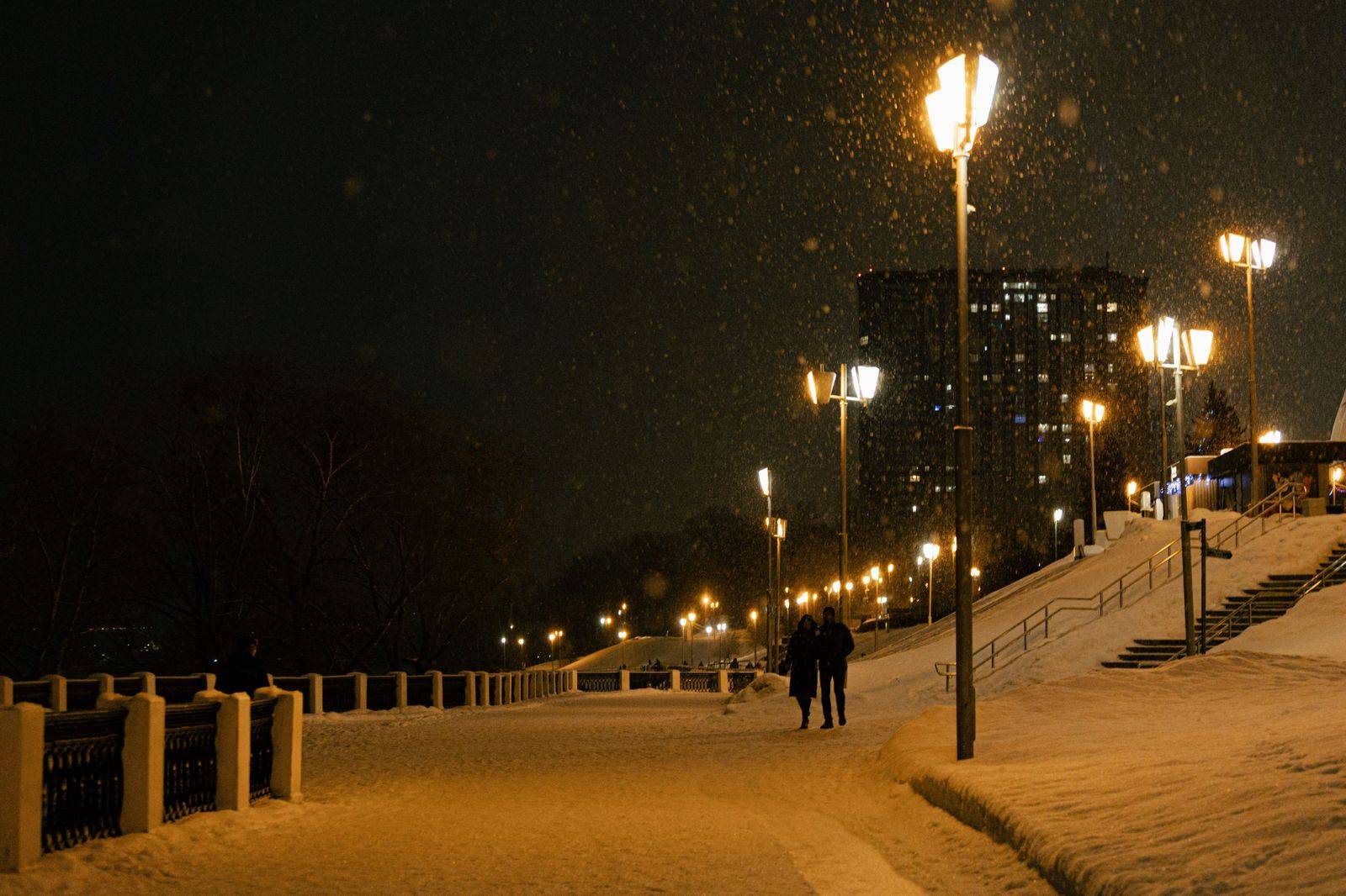 A snowy Toronto street at night with city lights, the kind of evening a warm chauffeured car makes easy