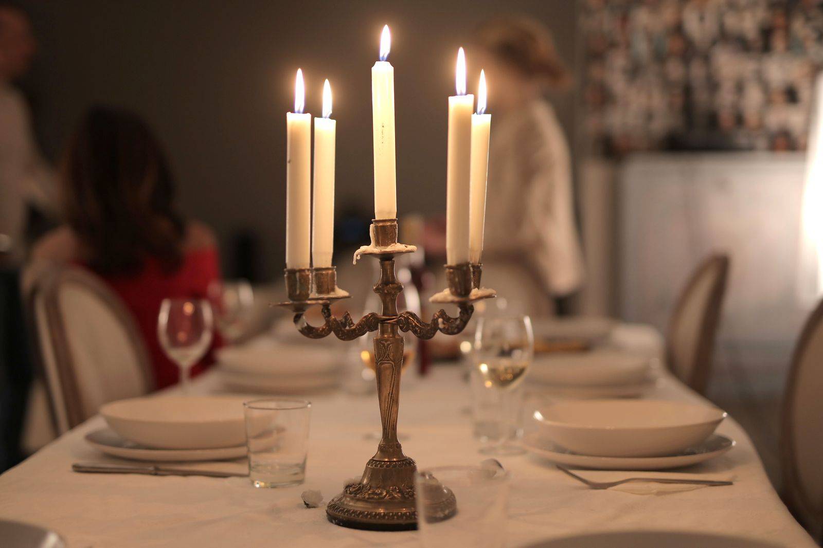 A restaurant table set with candles for a winter prix fixe dinner