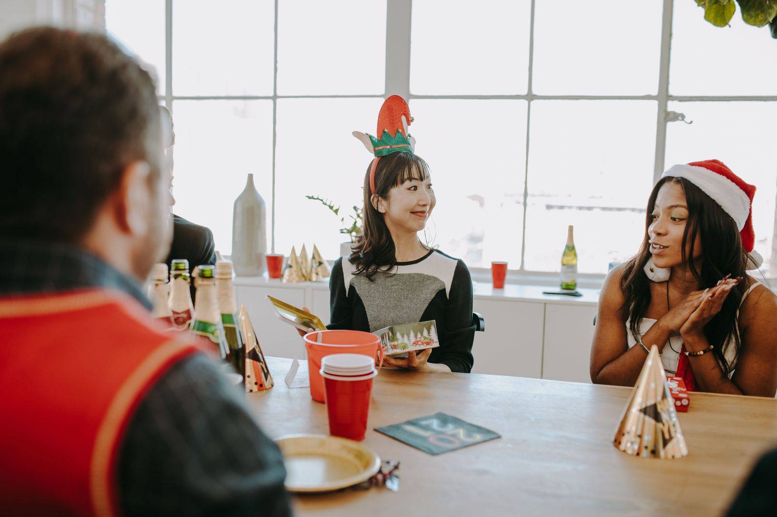 Colleagues celebrating at an office Christmas party before their chauffeured rides home