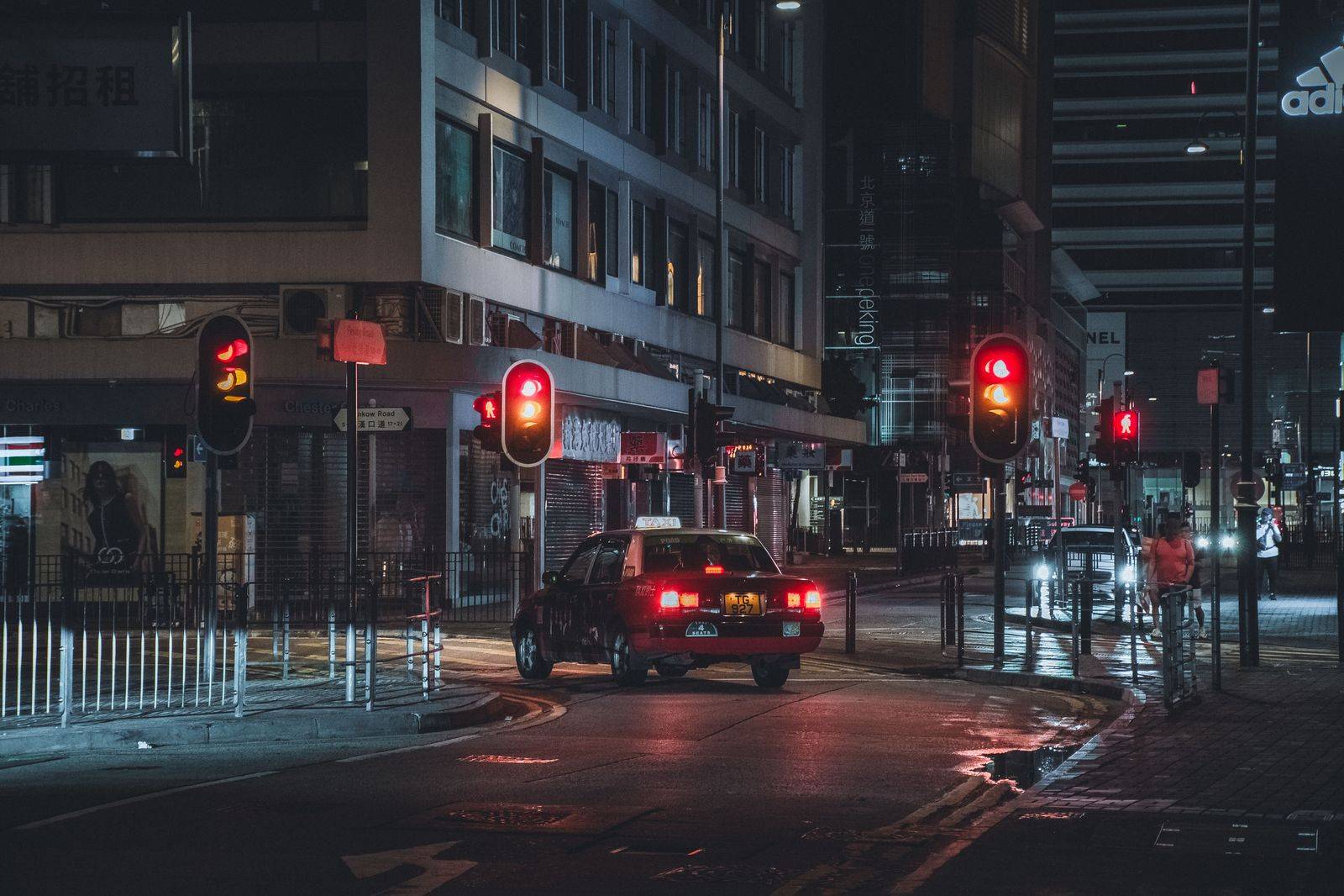 A black sedan on a downtown Toronto street at night