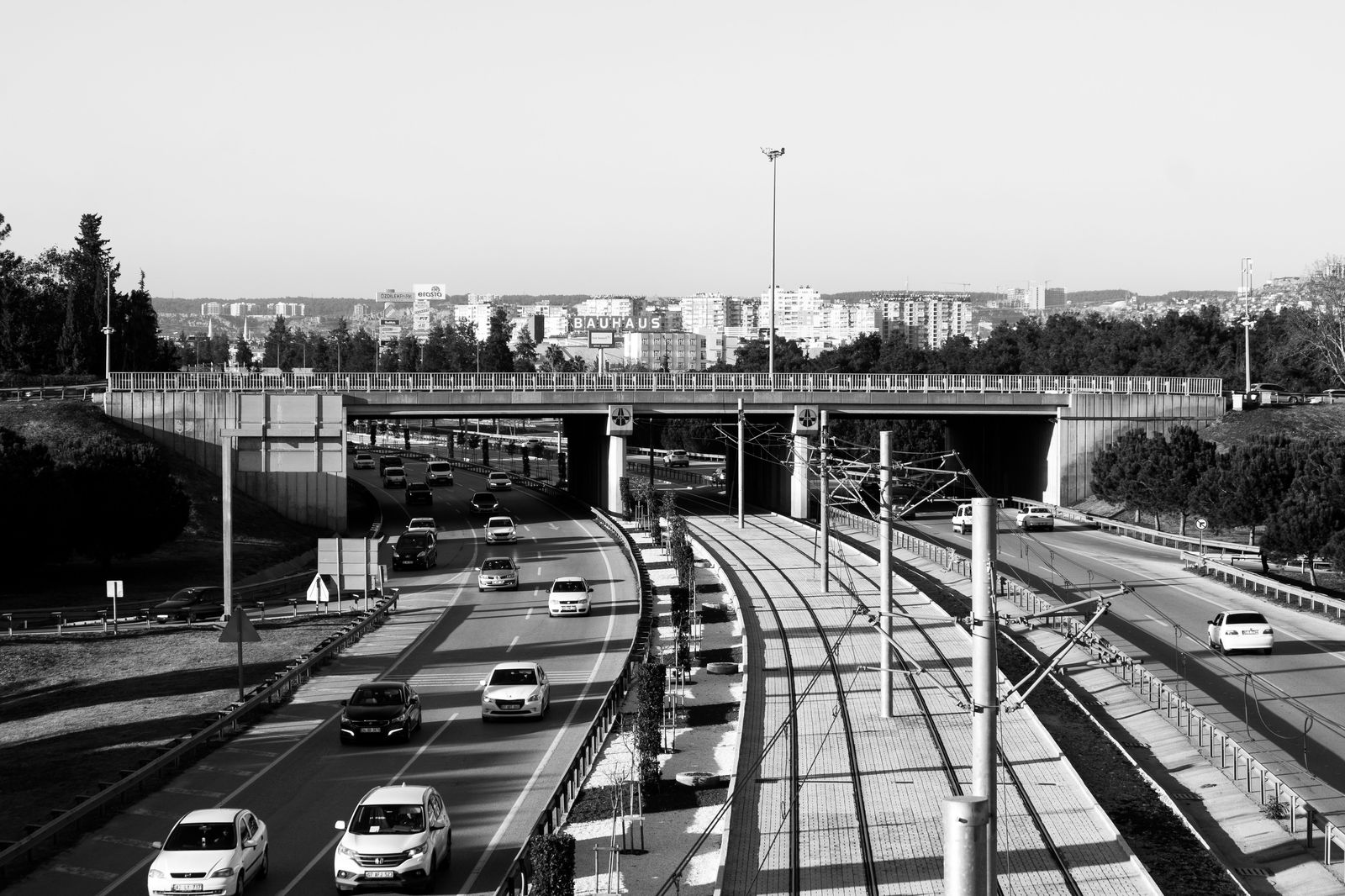 A black sedan approaching an international bridge crossing between New York and Ontario