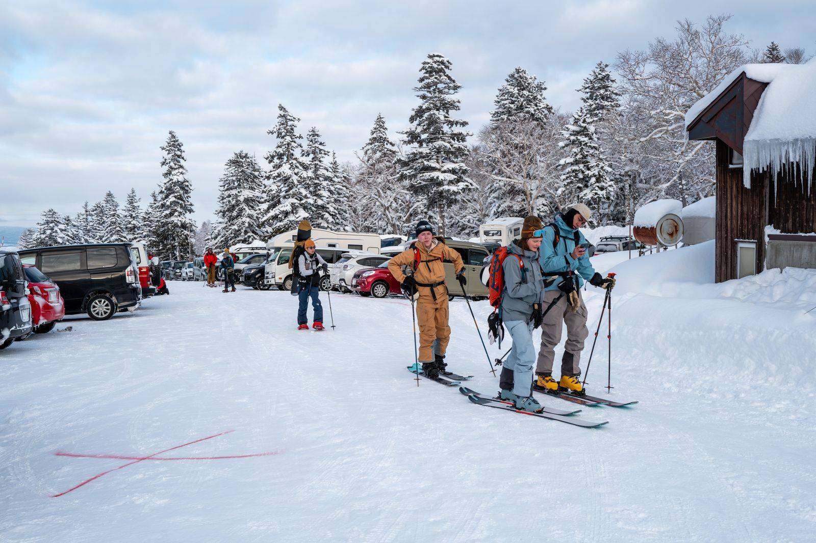 Skis and boots being loaded into the back of a chauffeured SUV
