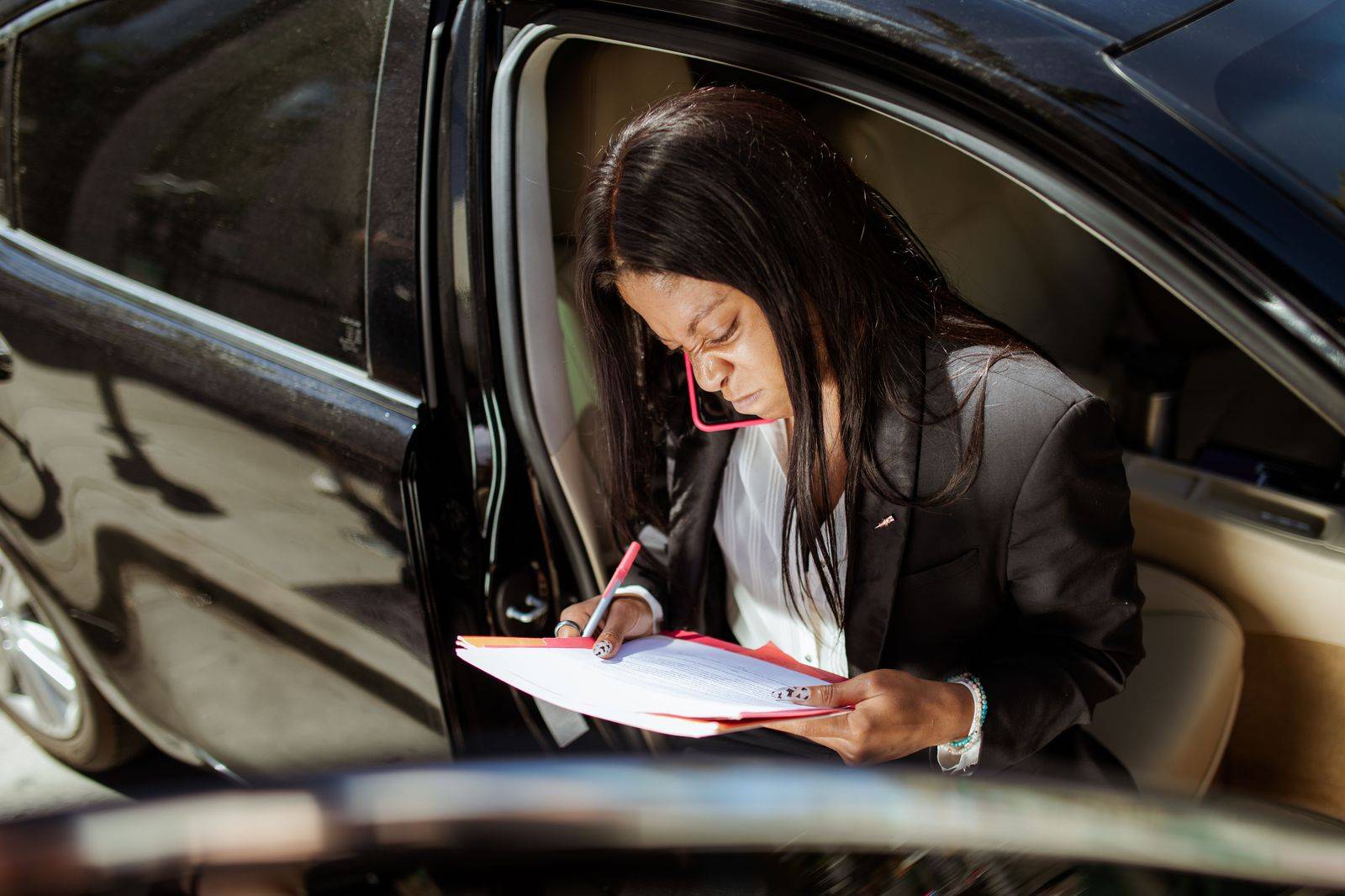 An executive reviewing papers in the back seat on the drive from London to Toronto