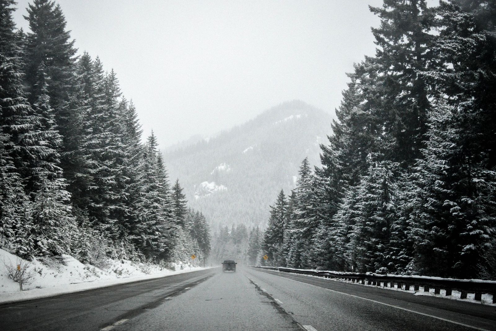 Black luxury SUV on a snowy Ontario highway on the way north from Toronto