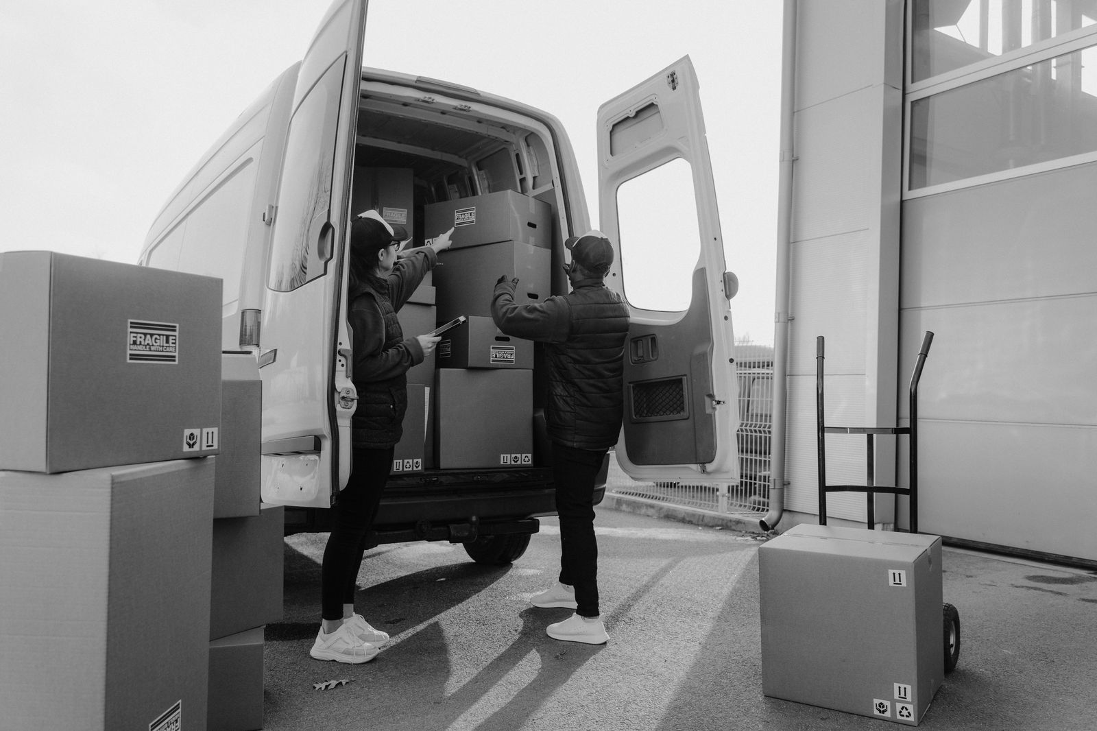 Group of travellers loading suitcases into a chauffeured Sprinter van at a Toronto hotel