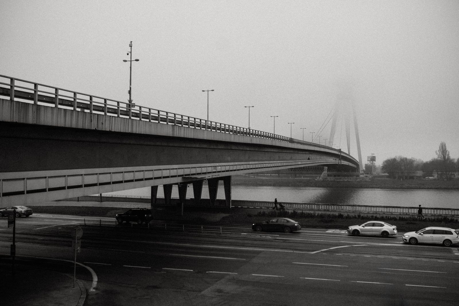 A black sedan approaching a river bridge on a chauffeured trip from Toronto to the United States