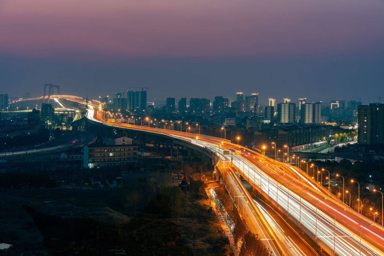 Evening traffic on a Toronto expressway with the city skyline behind
