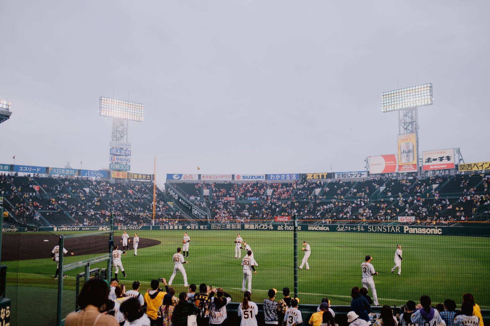 Crowds arriving at a Toronto ballpark on a summer evening