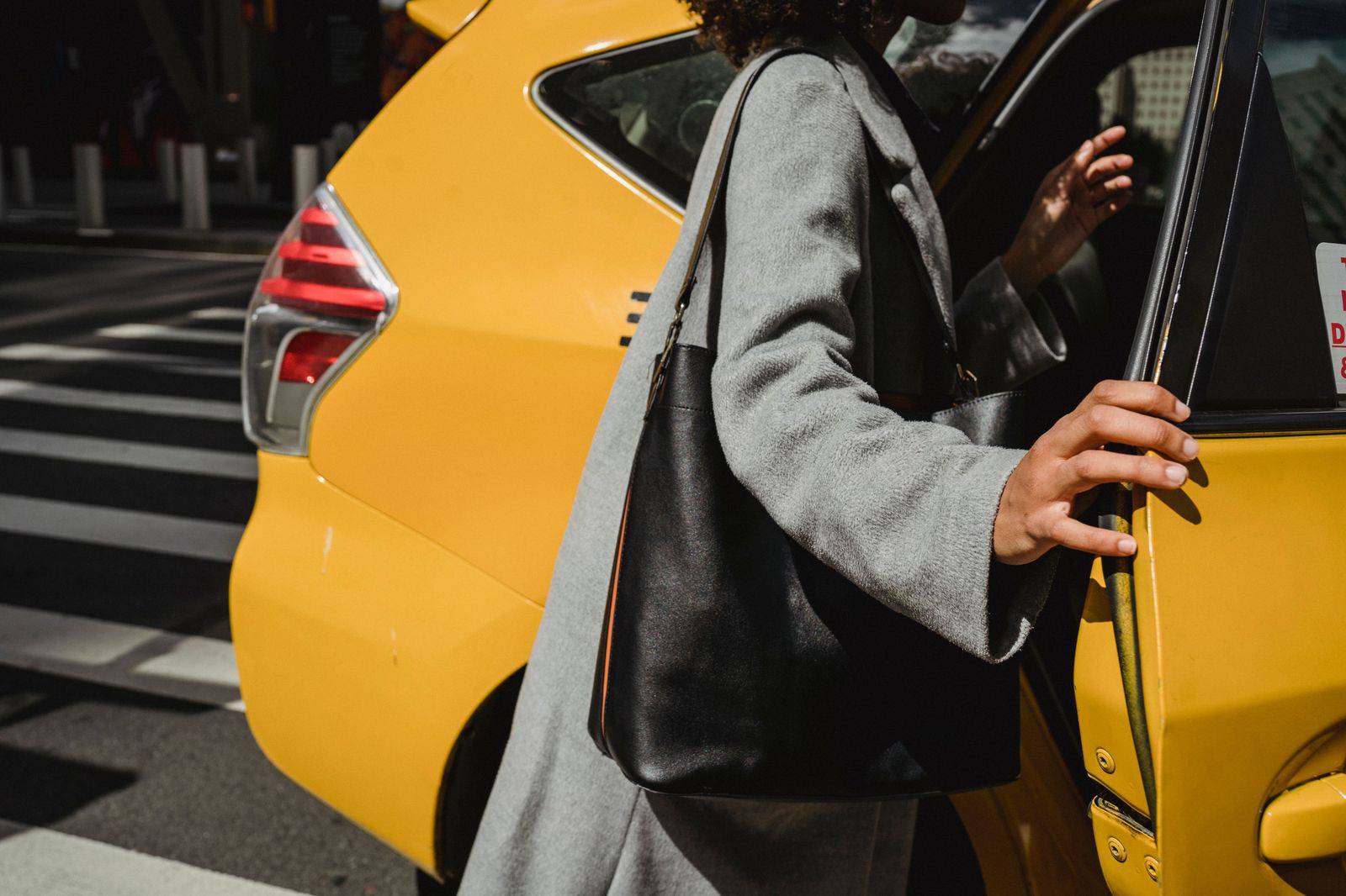 A chauffeur waiting with an umbrella outside a midtown Toronto residential building