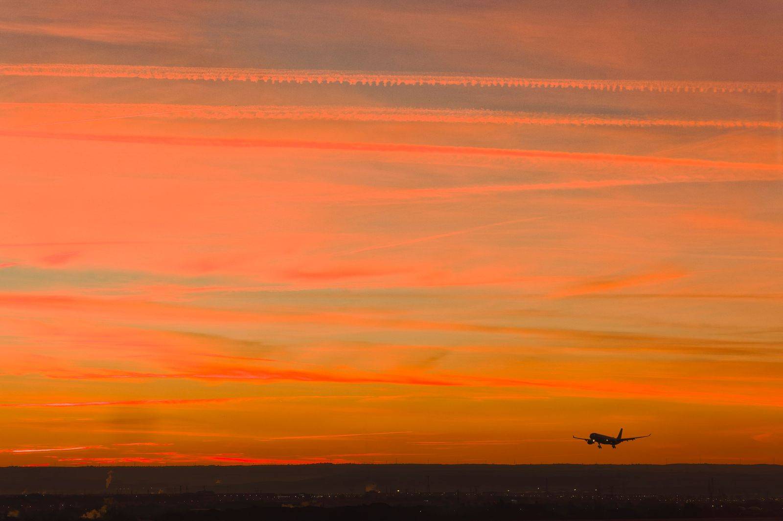 An airplane landing over a highway near Toronto Pearson at dusk
