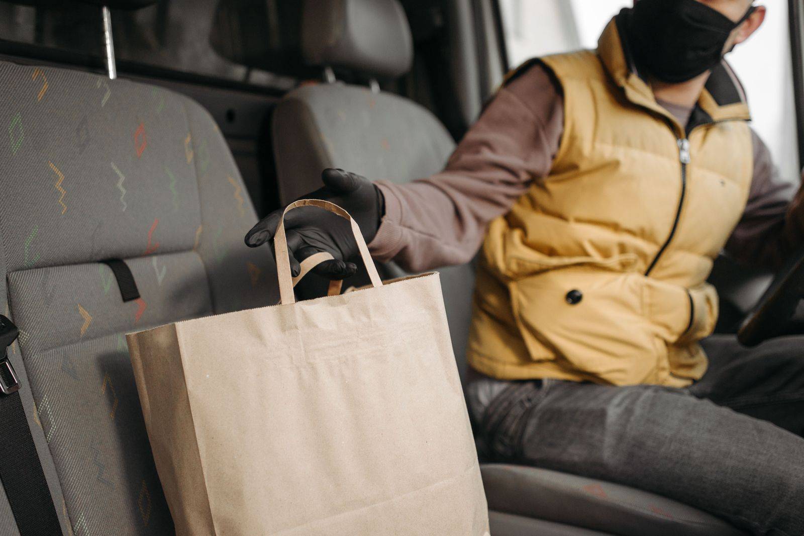 Shopping bags on the back seat of a black car after a Bloor Street afternoon