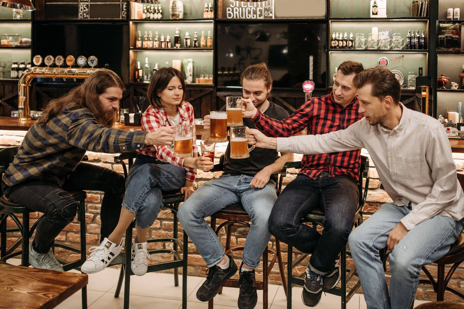 Bachelor party group raising glasses at a Toronto bar before the chauffeur takes them home