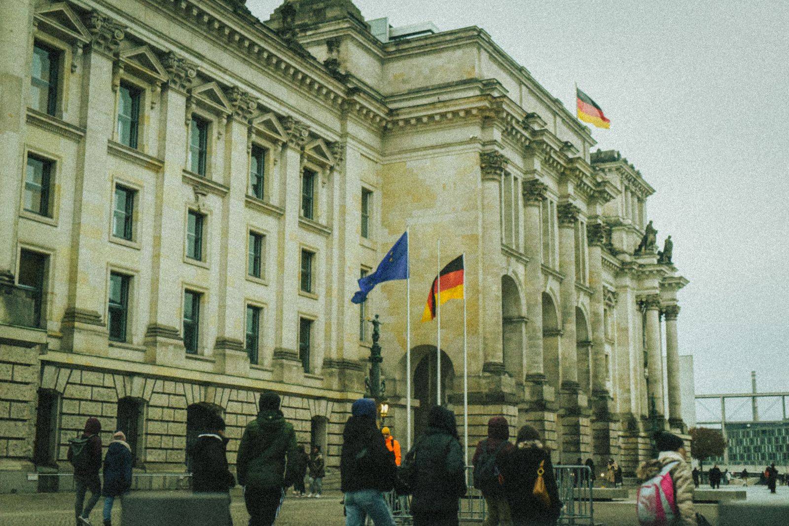 Columns and flags at a government building, the kind of address where official cars arrive to the minute