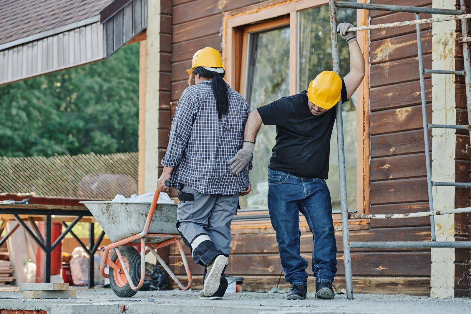 Workers boarding a chauffeured passenger van at a site entrance at the start of a shift