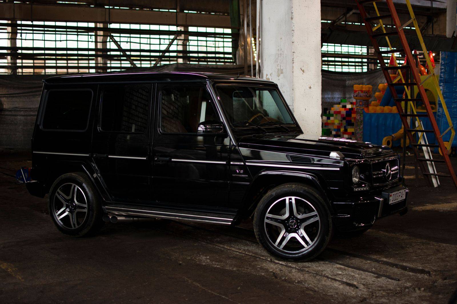 A black SUV holding outside a studio building, ready for a cast member at wrap
