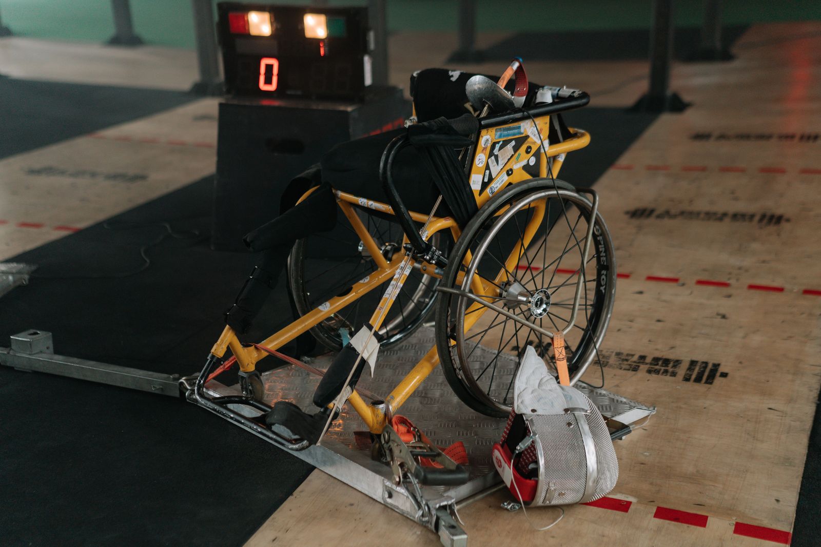 A folded wheelchair beside the open trunk of a black car before a hospital appointment
