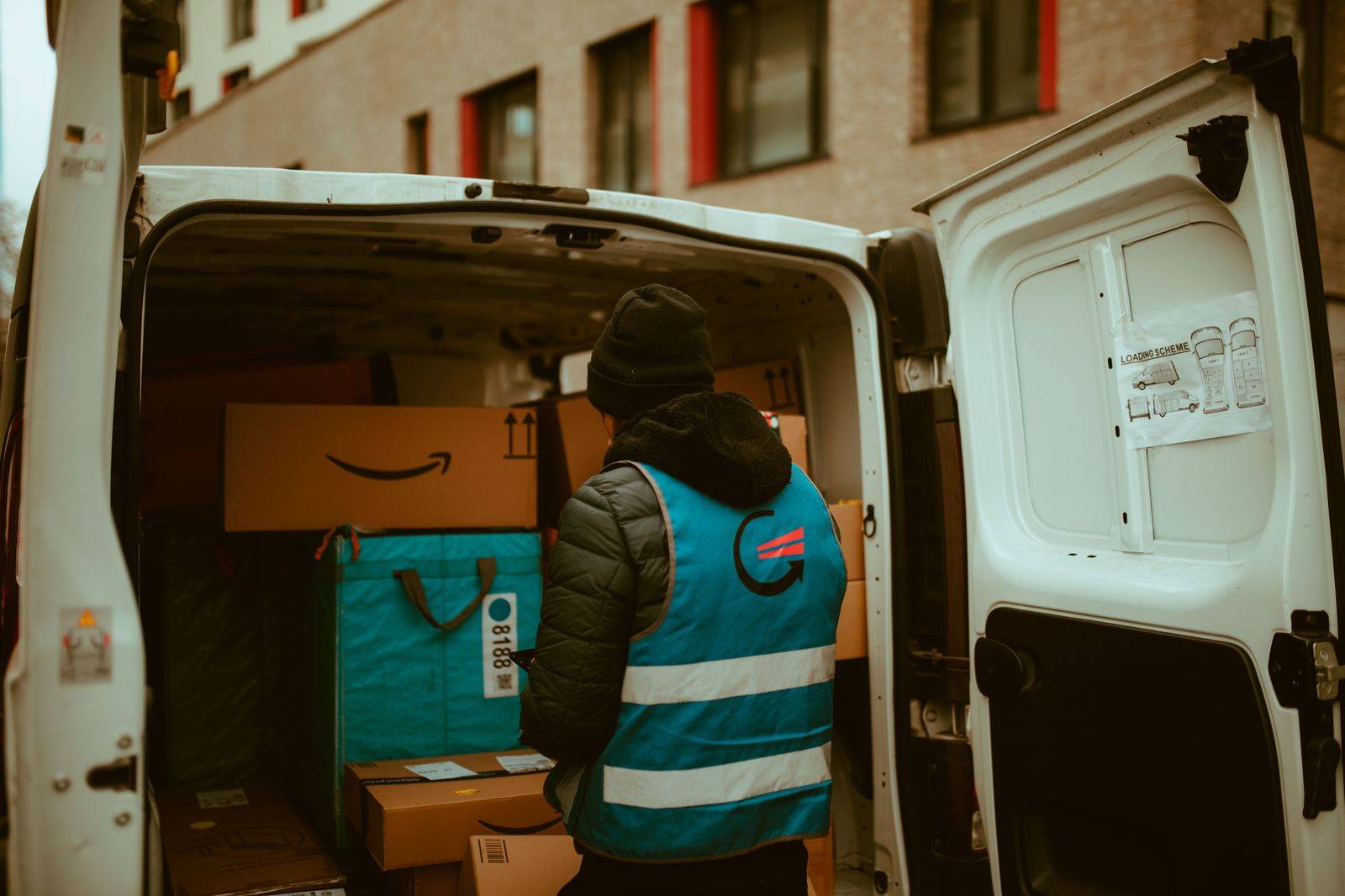 A chauffeur loading luggage into an SUV before a Toronto to London trip