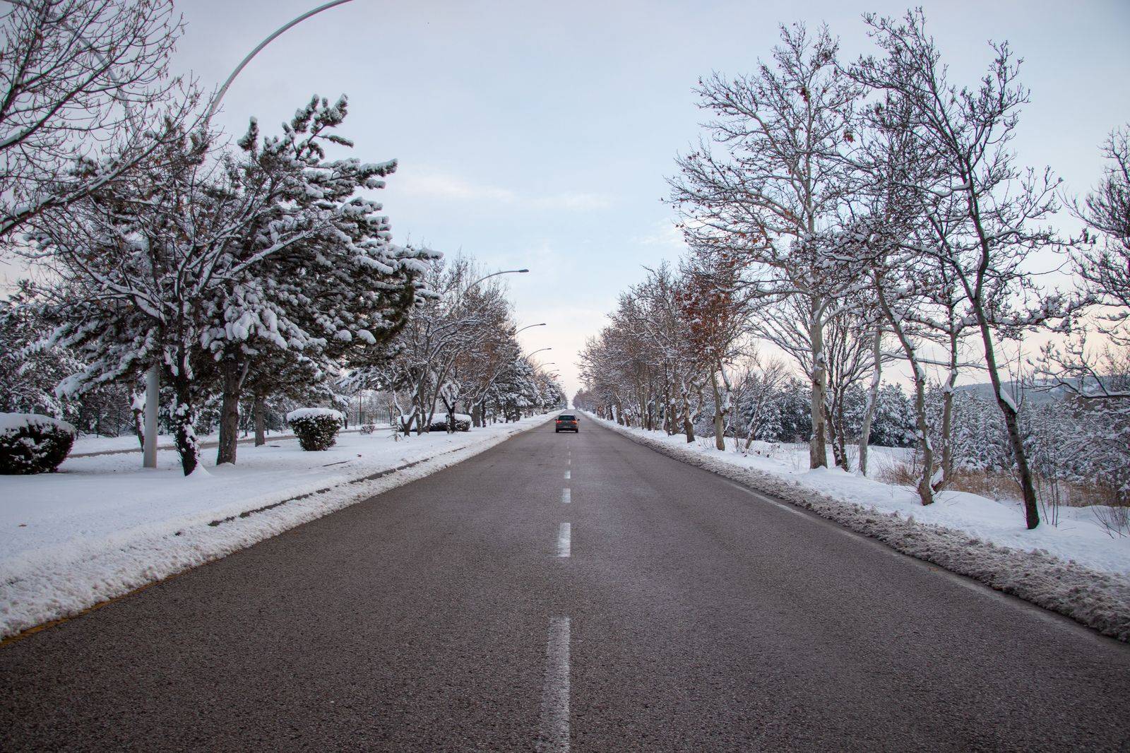 A four-lane Ontario highway in winter with light snow and traffic