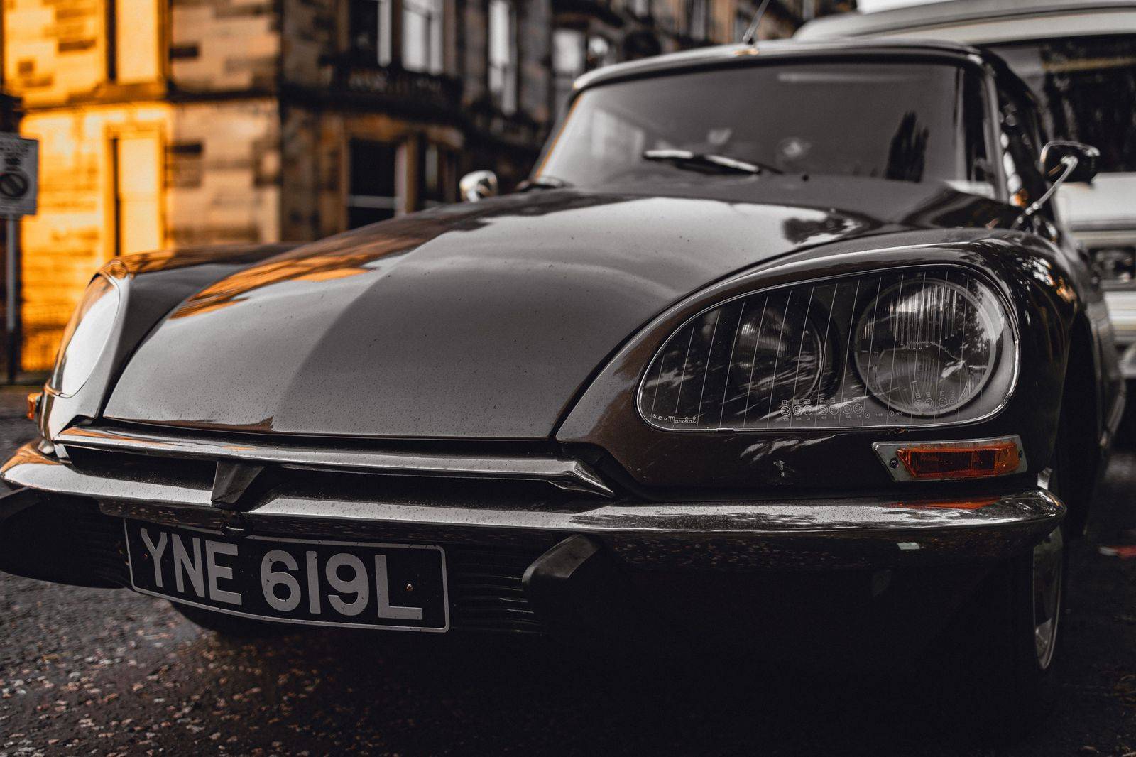 A black sedan parked on a historic stone street