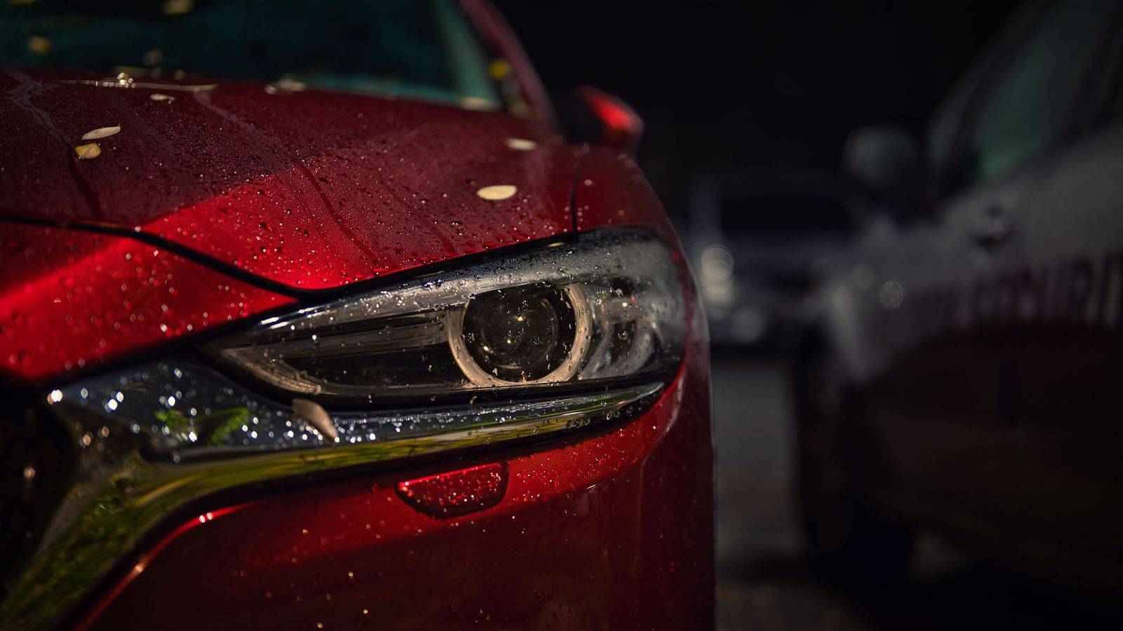 Black business sedan at night in downtown Toronto