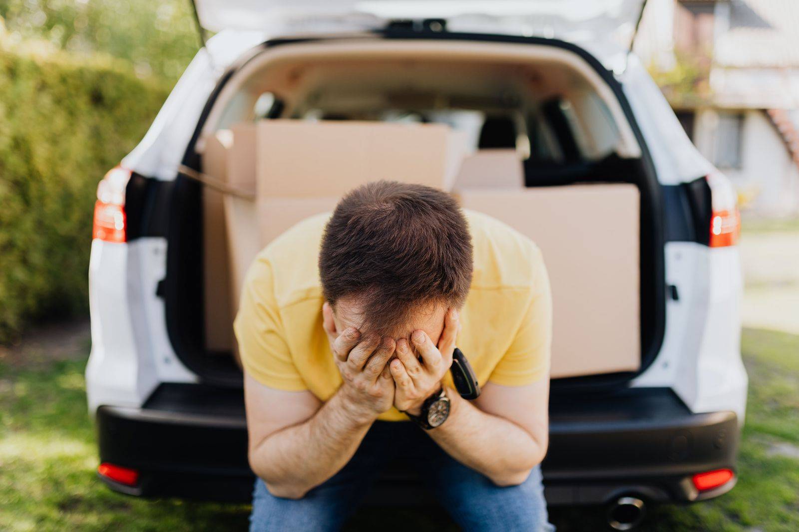 Family loading suitcases into the back of a black SUV for an airport run