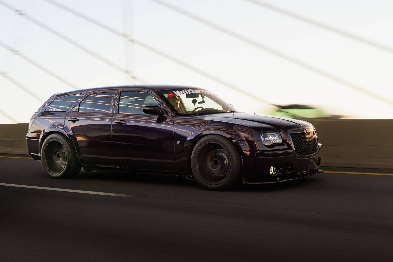 A black sedan on the highway at dusk, heading home from a casino near Toronto