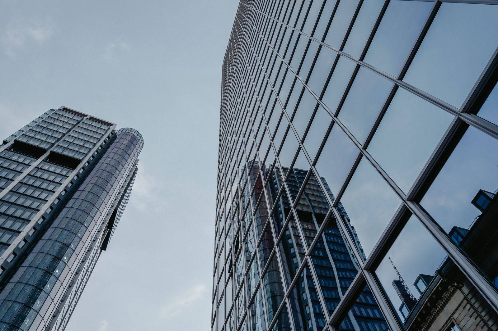 Glass office towers in Toronto's Financial District, where corporate cars wait at the curb