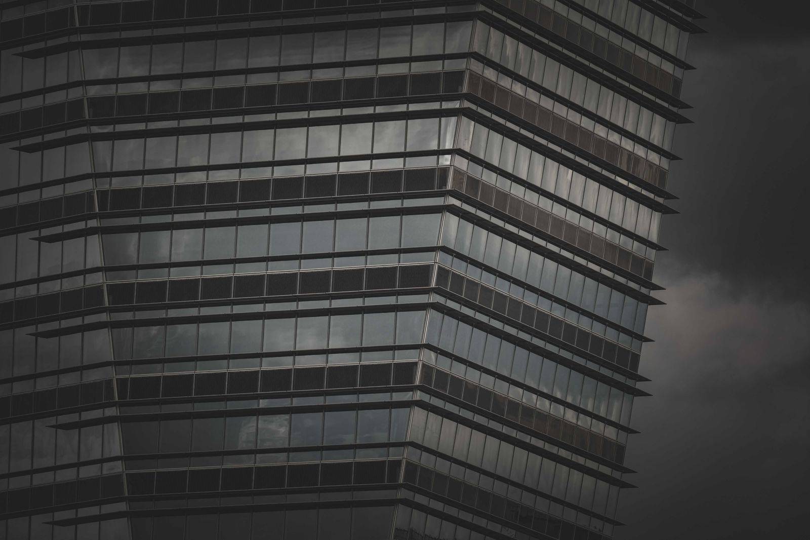 A black chauffeured car waiting near a downtown Toronto office tower during an hourly booking