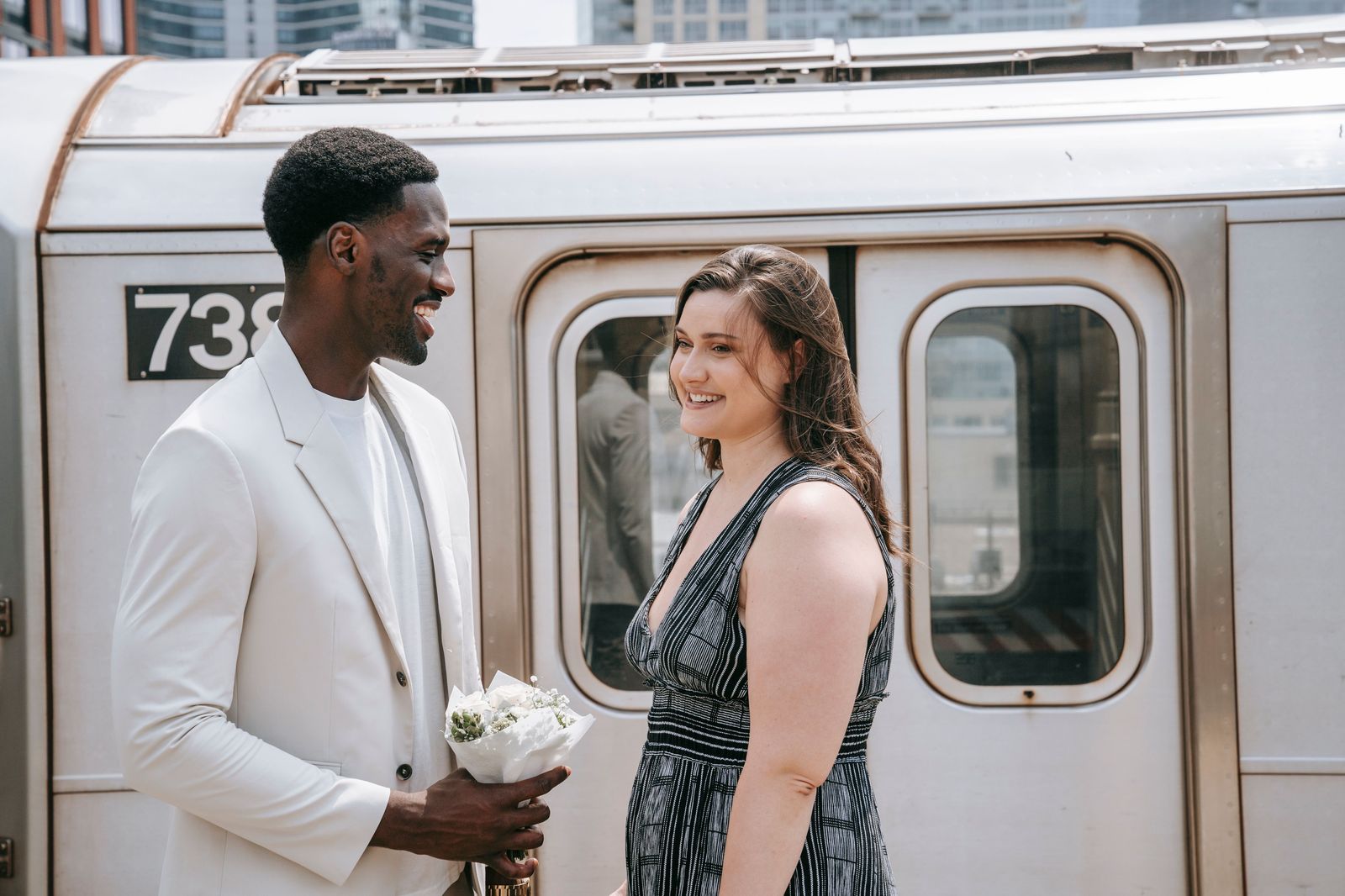 A wedding couple standing beside a black limousine before leaving for their Toronto reception