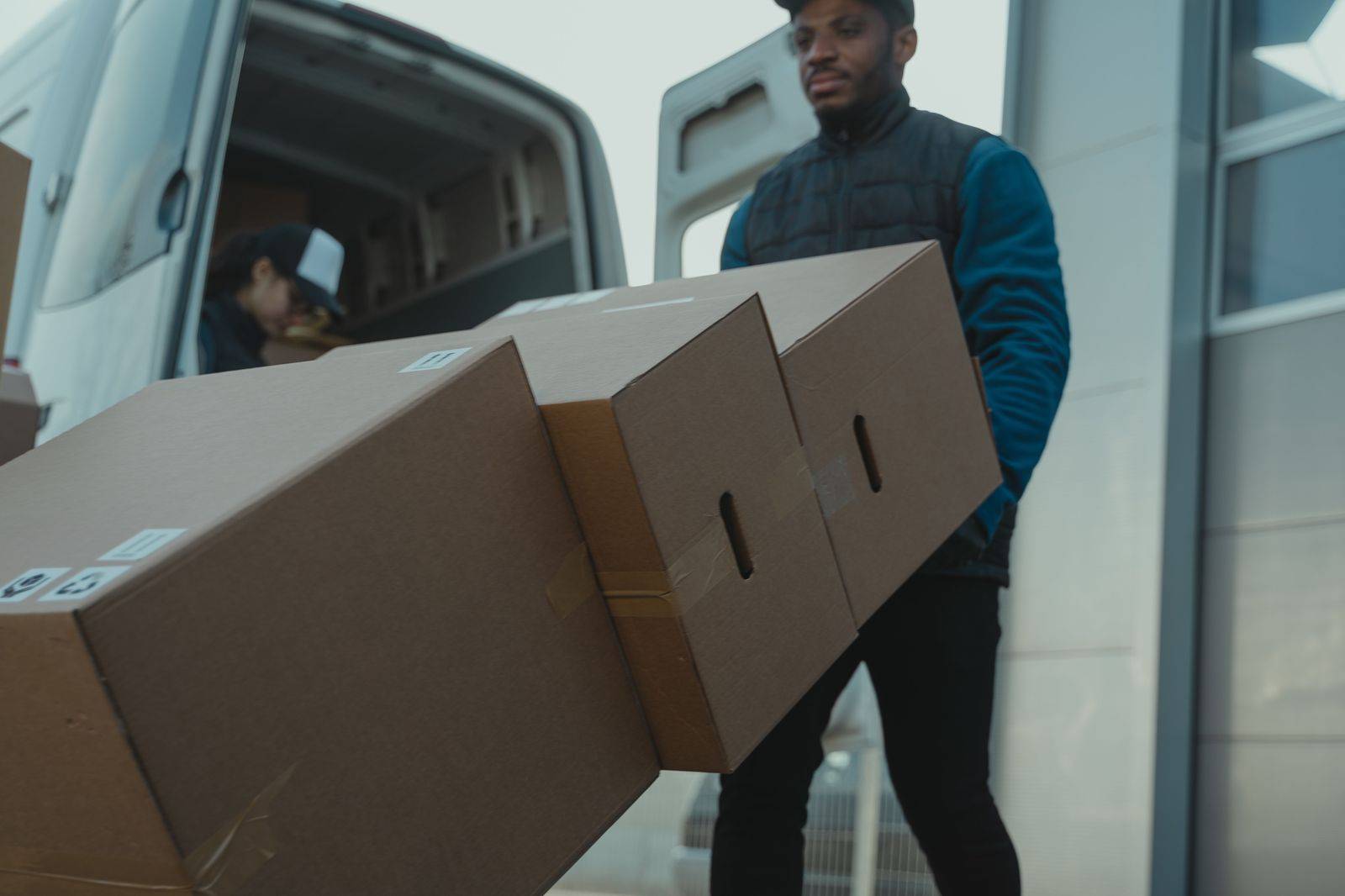 A black luxury SUV with a chauffeur loading suitcases for a Toronto airport run