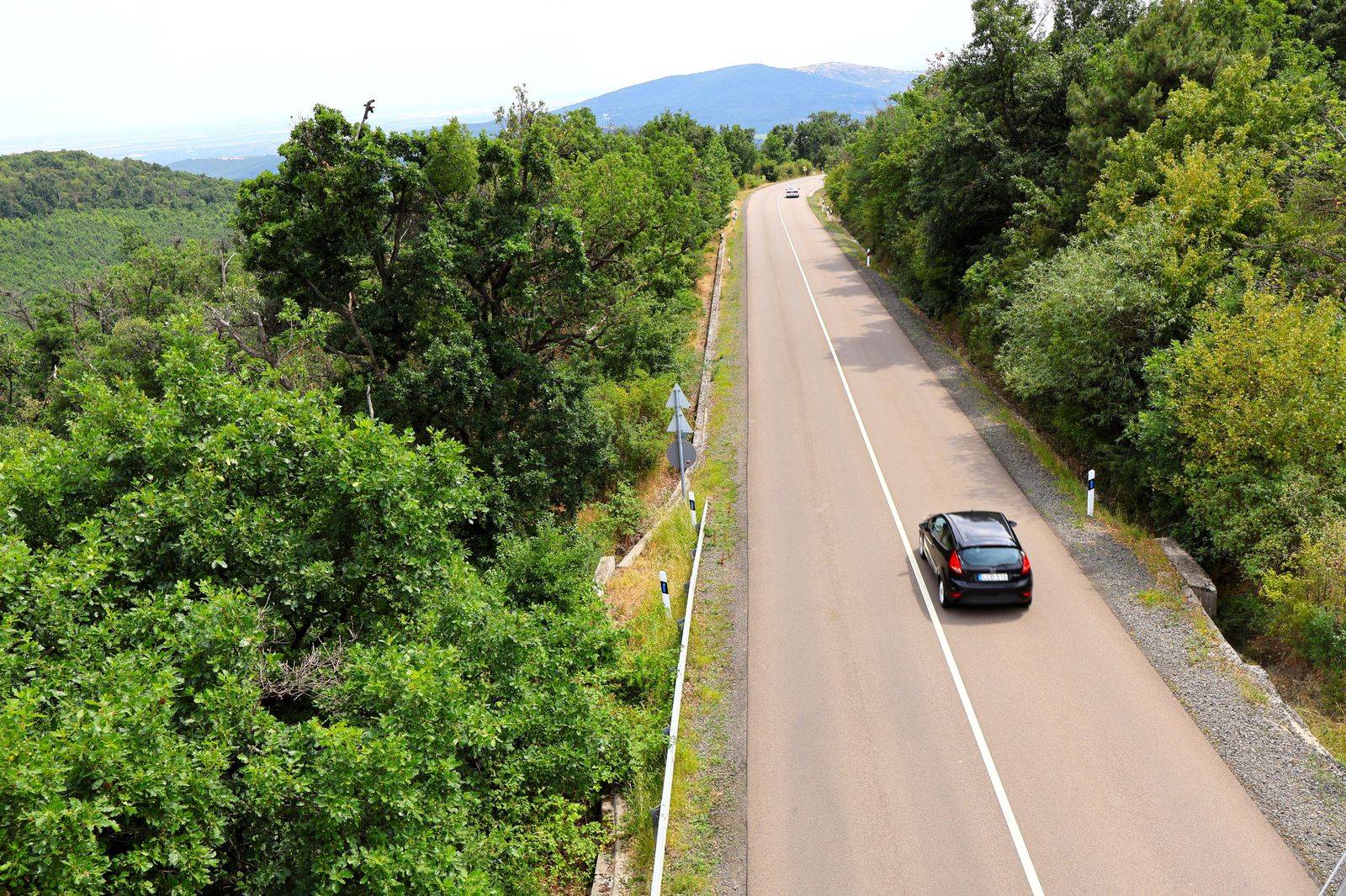 A black car on a scenic parkway, the kind of drive a private Niagara tour includes