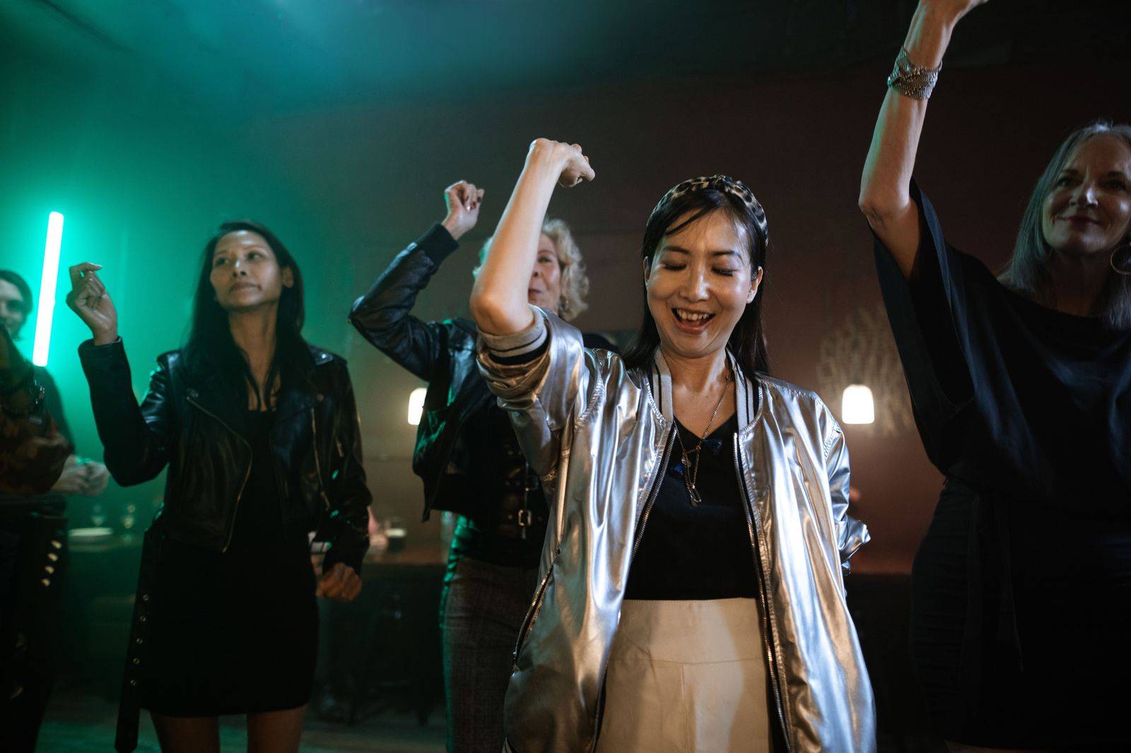 Friends dance under coloured lights inside a party bus in Toronto