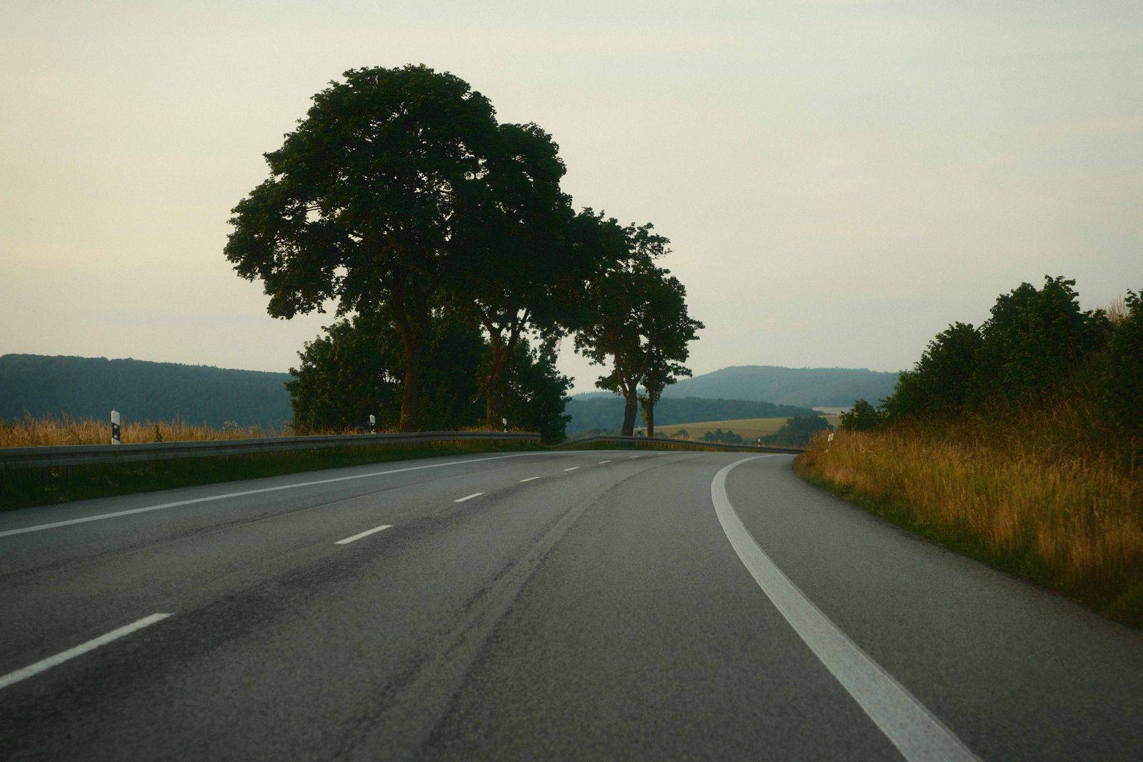 A black van on an Ohio interstate past open farmland on the way to Toronto