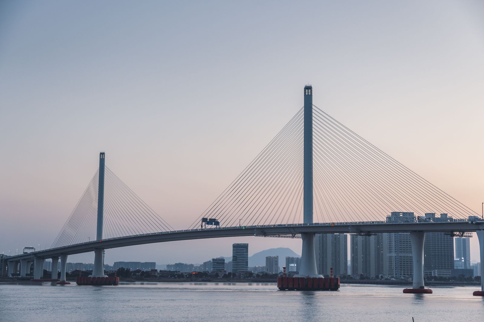 A cable-stayed bridge carries traffic over the Detroit River between Windsor and Detroit