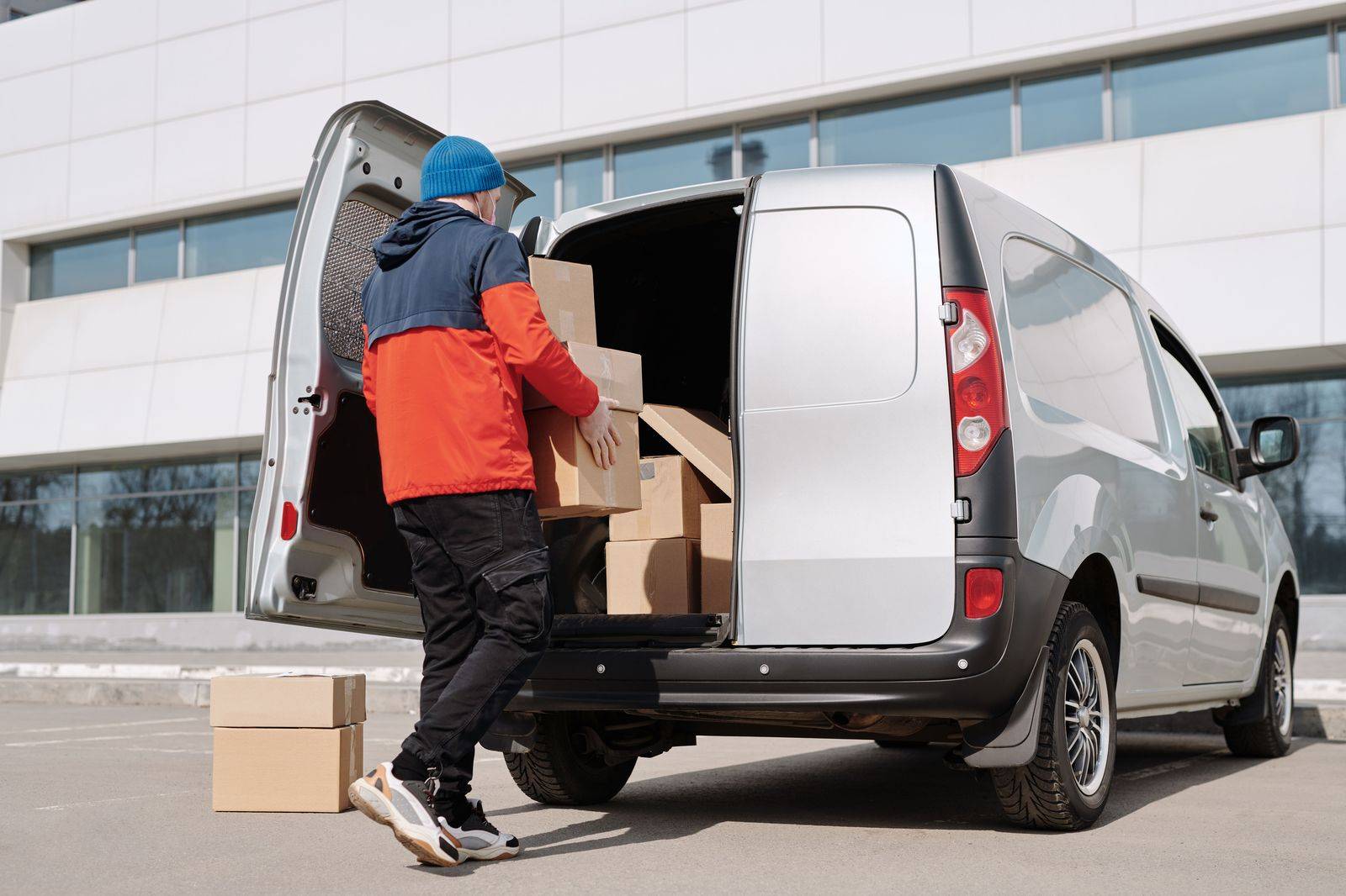 A chauffeur loading suitcases into an SUV before the long drive between New York and Toronto