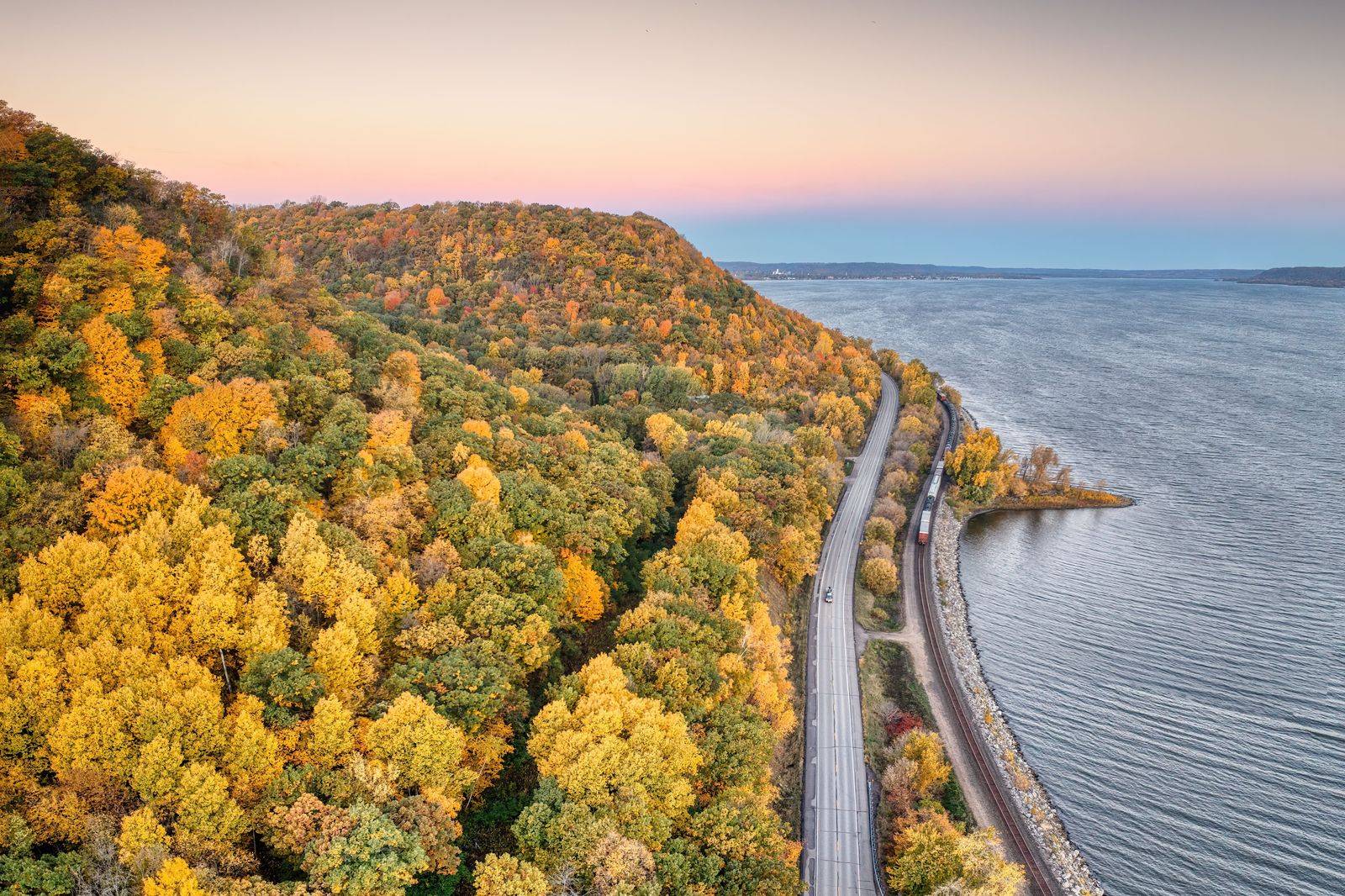 A tree-lined lakeshore road in autumn on the drive between Rochester and Toronto