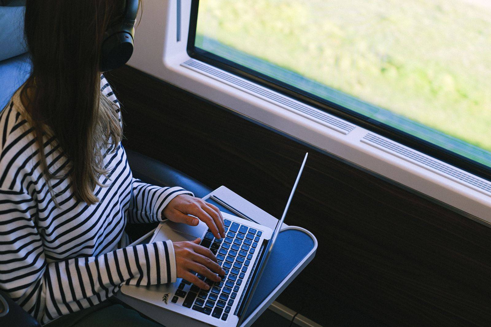 A passenger works on a laptop in the back seat during the drive from Toronto to Washington